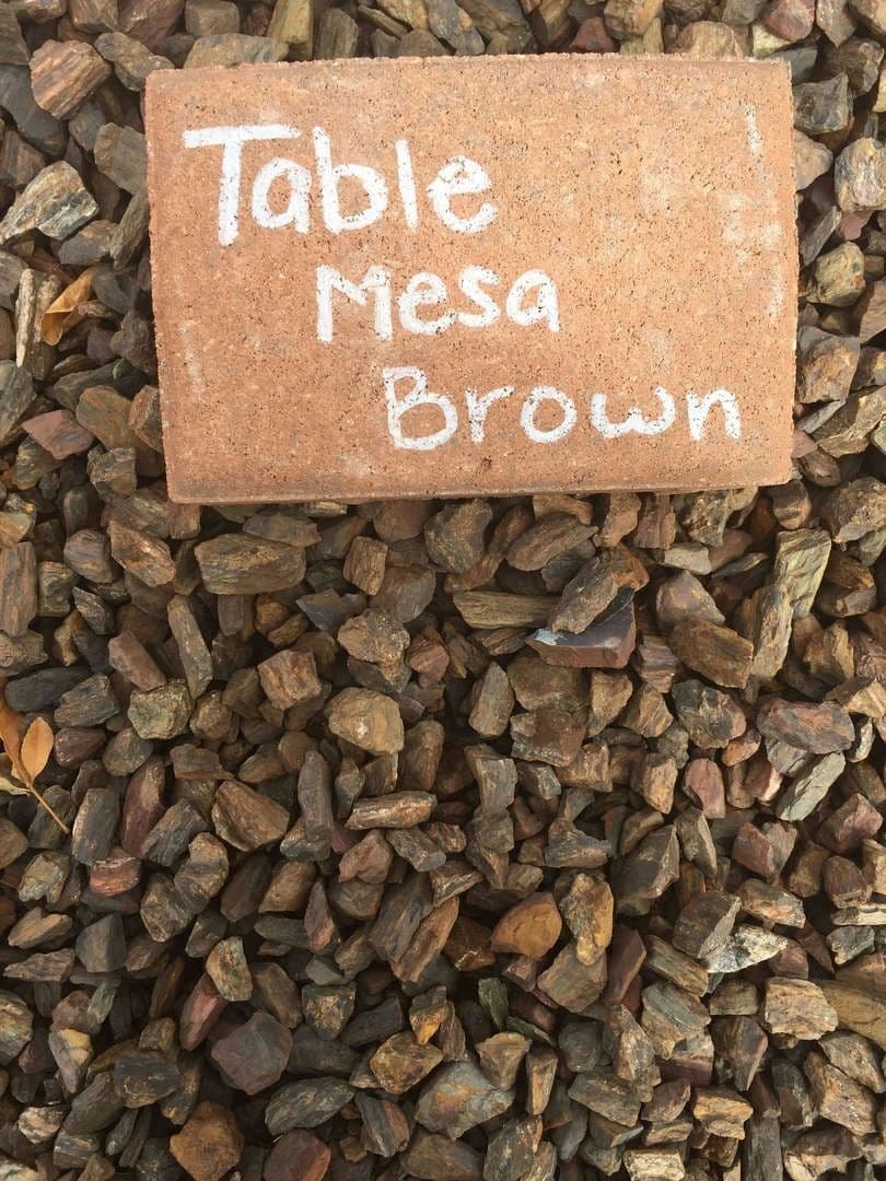 Table Mesa Brown rock sample on gravel background for landscaping and design.