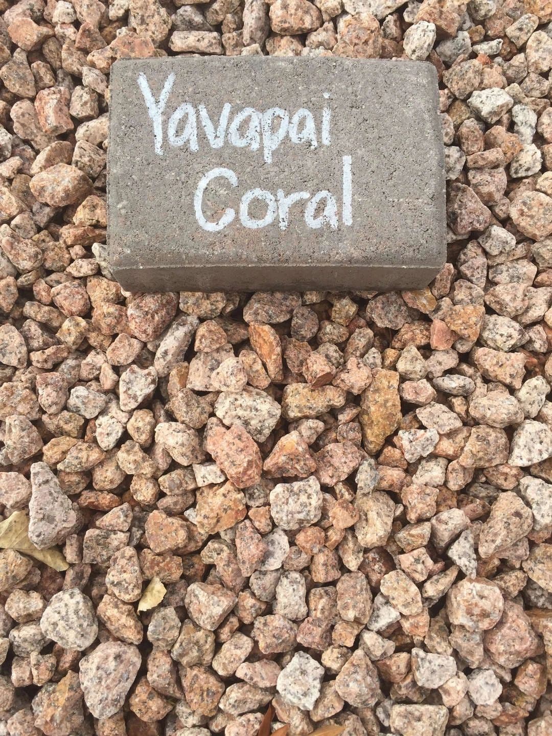 Yavapai Coral stone displayed on a bed of decorative gravel.