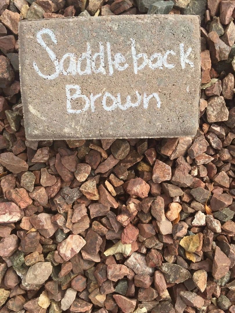Saddleback Brown stone sample on gravel background for landscaping or construction.
